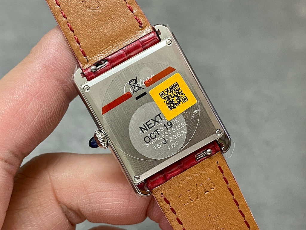 Cartier watch caseback with QR code, markings, and red crocodile leather strap
