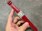 Cartier watch with red crocodile leather strap and silver square dial, Roman numeral indices