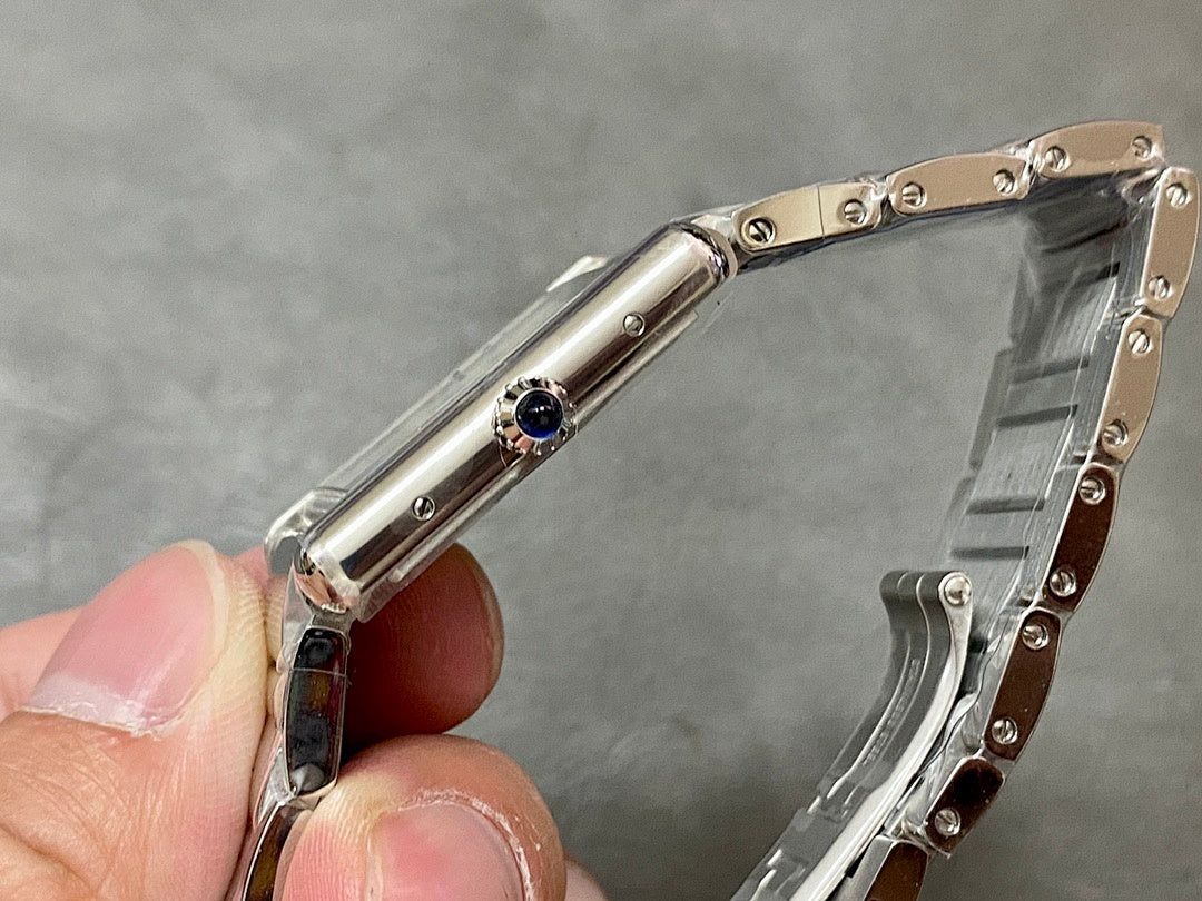 Stainless steel wristwatch side profile with crown and circular blue jewel