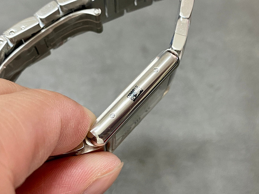 Stainless steel wristwatch case side with crown and pinholes