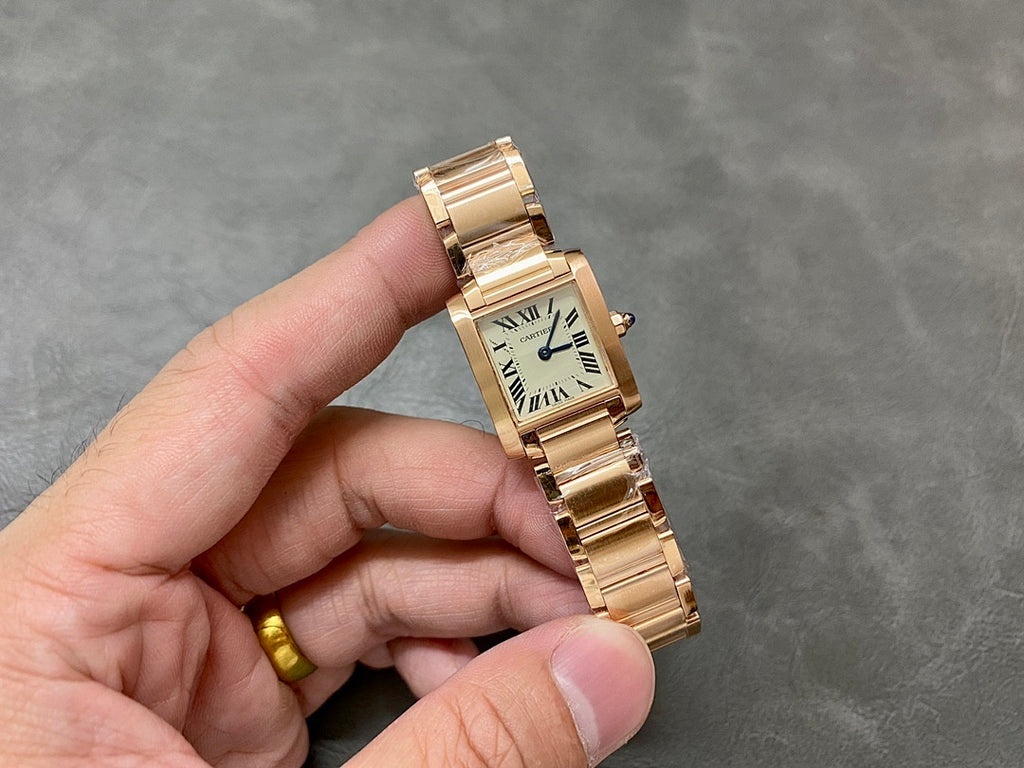 Gold-tone Cartier wristwatch with rectangular dial, Roman numerals, and linked bracelet