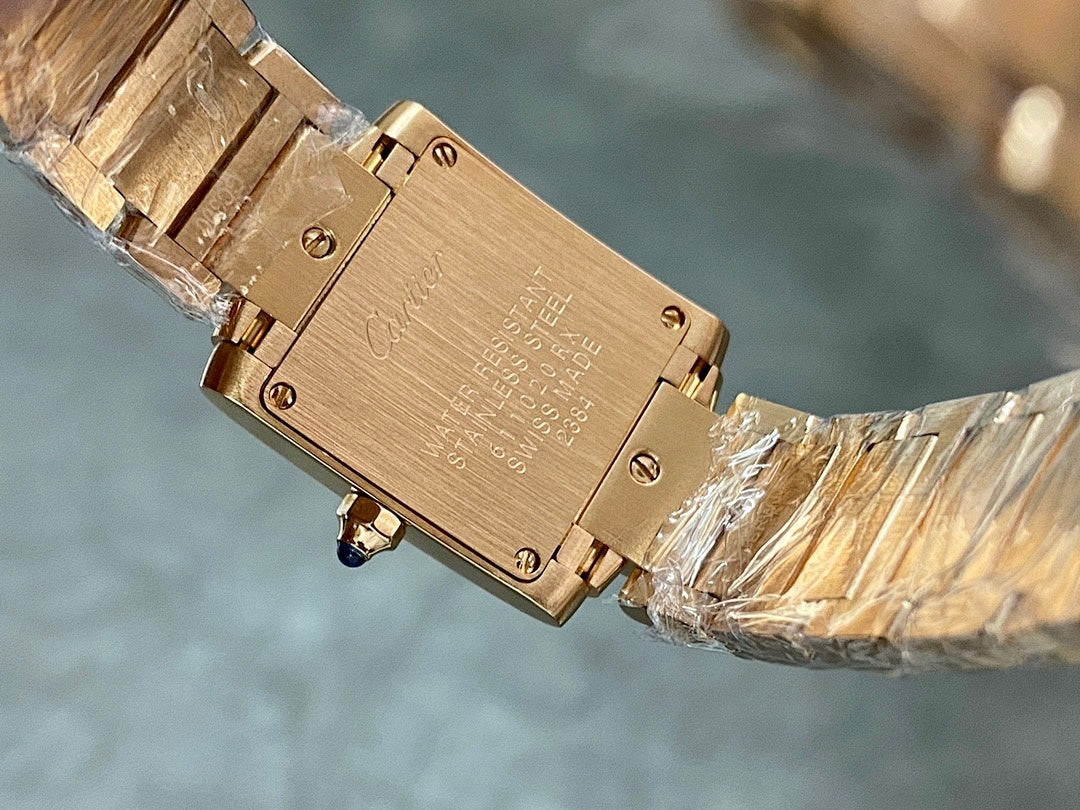 Engraved gold-tone Cartier watch caseback with screws, wrapped for protection