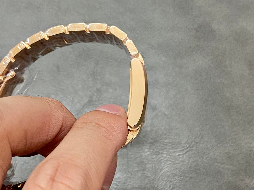 Gold-tone Cartier watch bracelet end and case profile, shown from the side