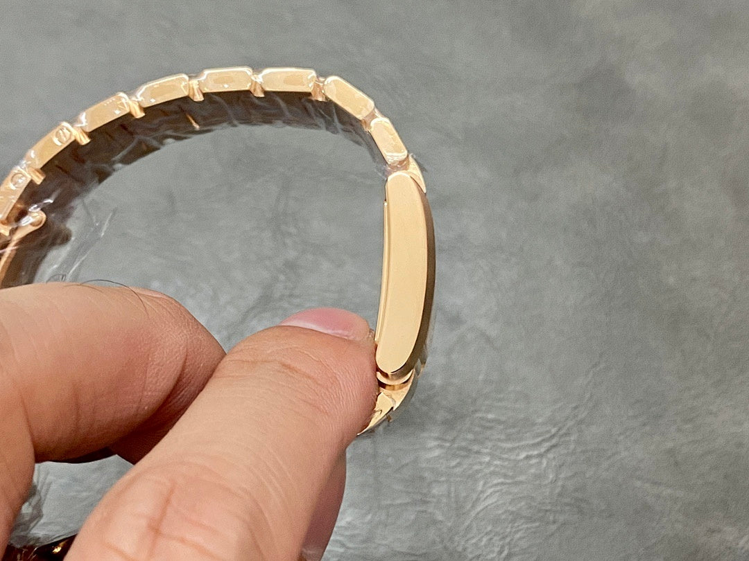 Gold-tone Cartier watch bracelet end and case profile, shown from the side