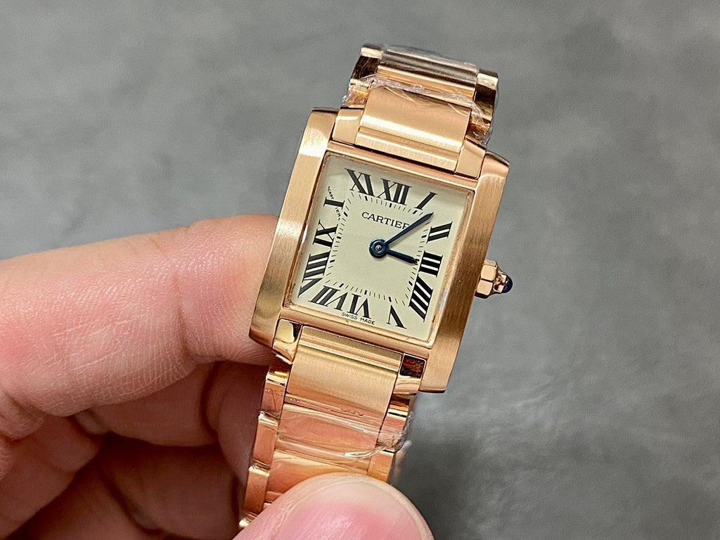 Gold-tone Cartier watch with rectangular face, Roman numerals, and blue hands