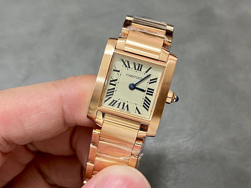 Gold-tone Cartier watch with rectangular face, Roman numerals, and blue hands