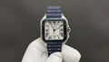 Wristwatch with blue strap and gold-tone square case, Roman numerals and blue hands