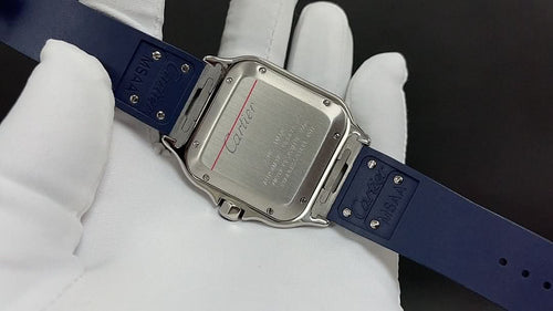 Wristwatch with blue rubber strap and gold-tone rectangular case, clasp and screws