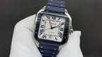 Luxury square watch with blue strap and gold-tone case, Roman numerals and date window