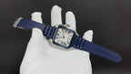 Wristwatch on blue strap with gold-tone square case, Roman numerals on dial
