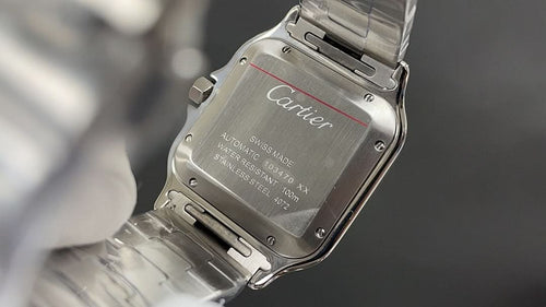 Cartier watch caseback with engraved metal panel and logo, stainless steel bracelet