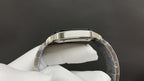 Cartier watch top view, stainless steel case with dark blue bezel accents
