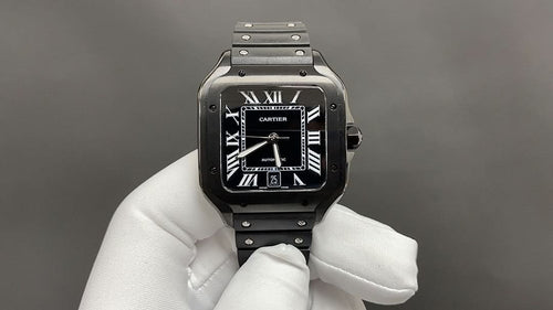 Cartier watch with black dial, Roman numerals, and black leather strap on silver-toned case.