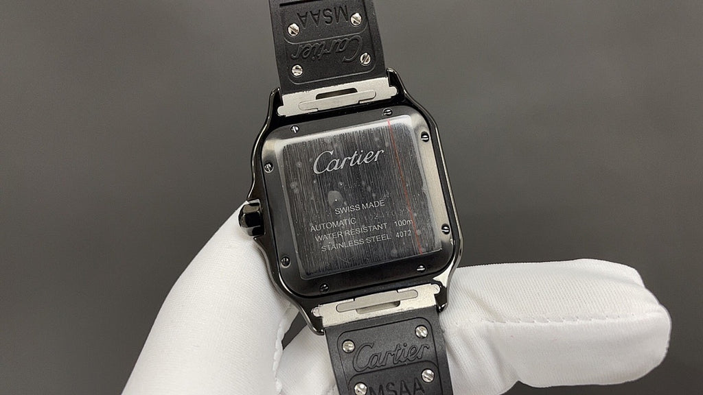 Cartier watch back with engraved case and strap, shown on a white-gloved hand.