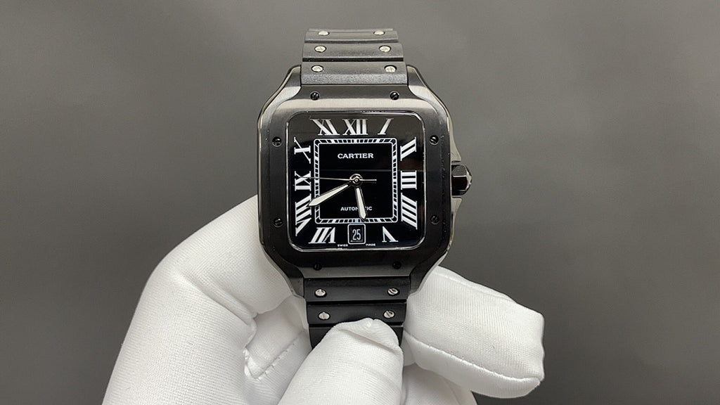 Cartier watch front view with black dial, Roman numerals, and black strap on silver case.