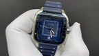 Blue dial Cartier watch with Roman numerals, gold-tone hands, blue strap
