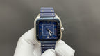 Blue-dial Cartier watch with Roman numerals, silver case and blue strap