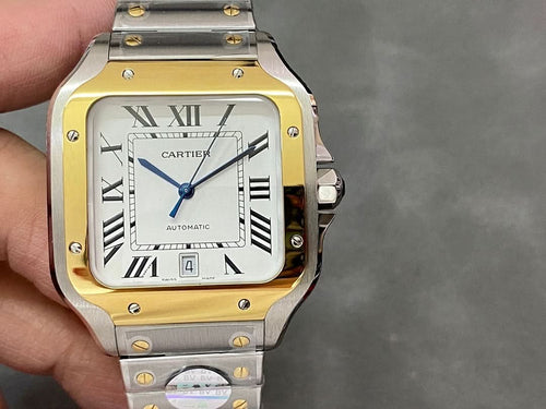 Cartier rectangular watch with gold bezel, roman numeral dial, metal bracelet, date window