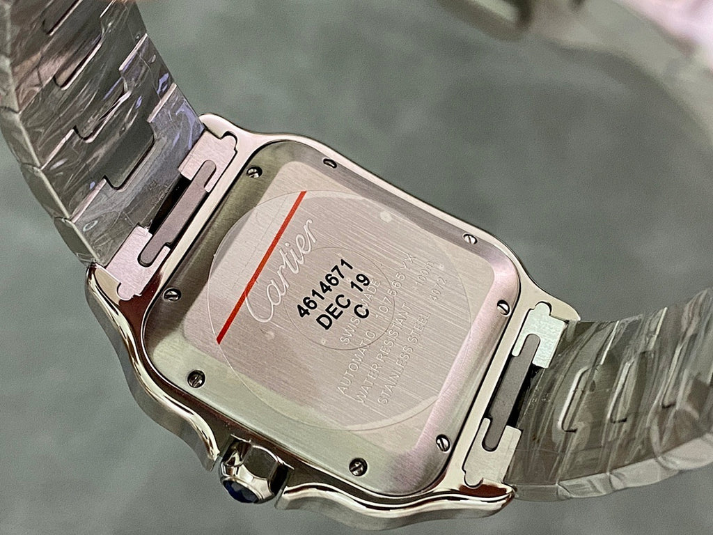 Cartier stainless-steel watch case back with engraved markings and clasp