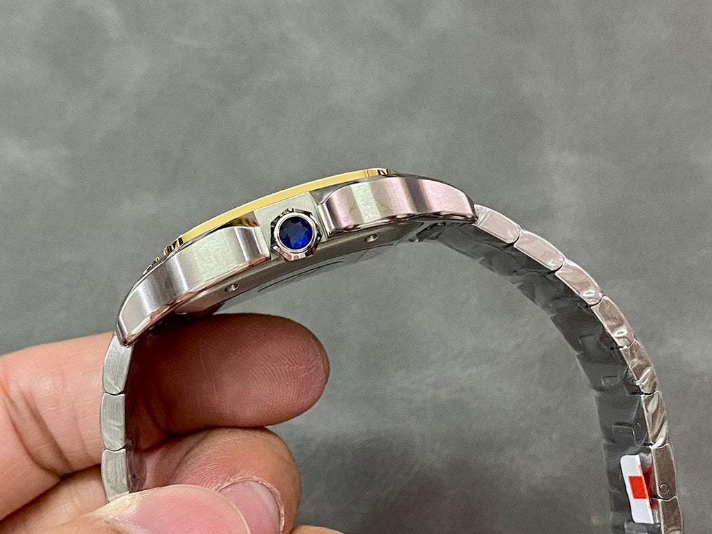 Cartier stainless-steel watch with gold bezel and blue crown jewel, side view