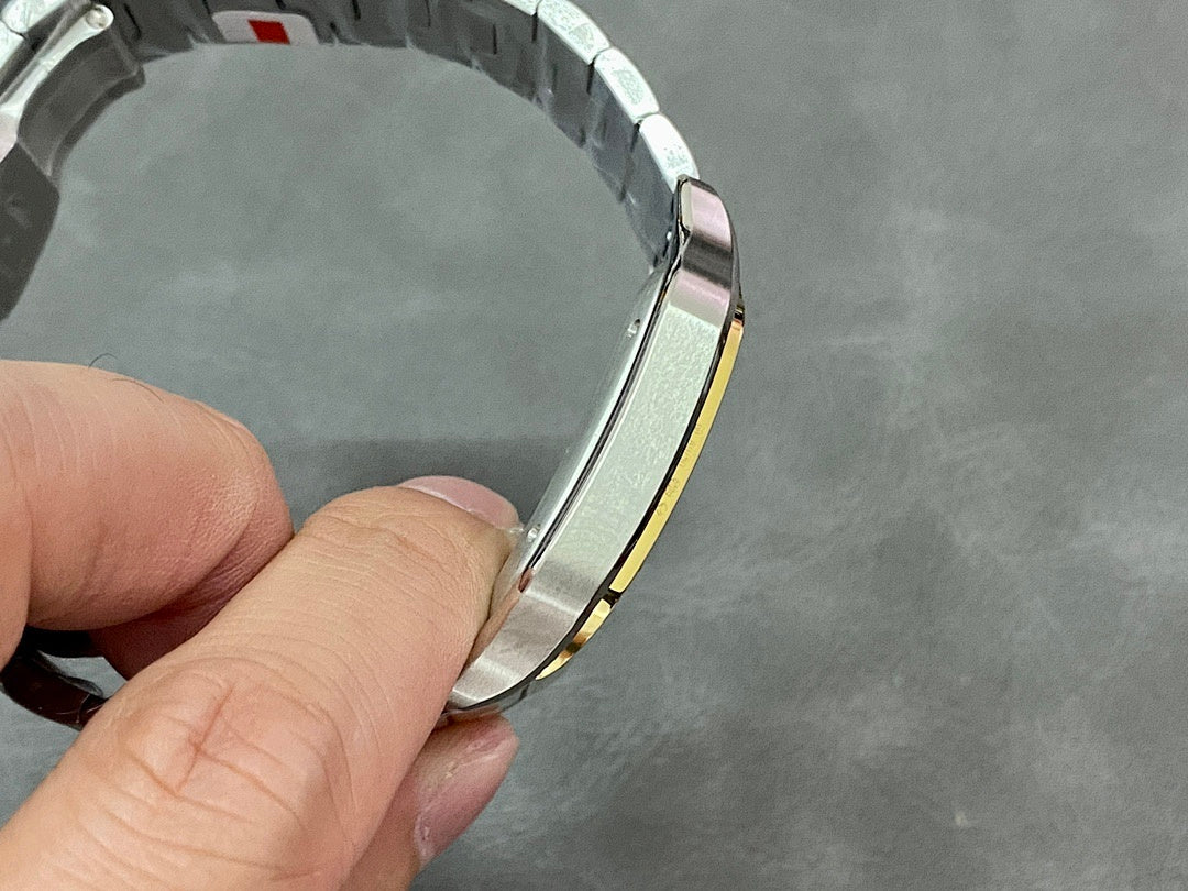 Cartier metal watch bracelet with gold accent band, close-up holding angle