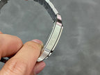 Silver metal watch bracelet link section, close-up