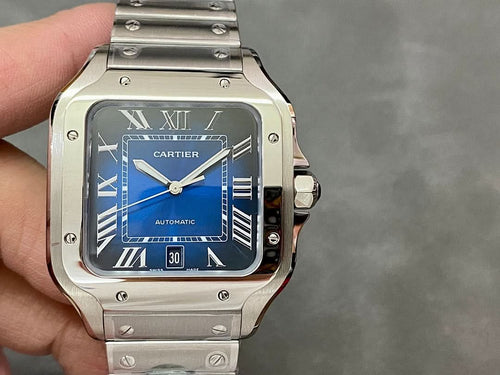 Cartier Santos watch, silver case with blue dial and metal bracelet in hand