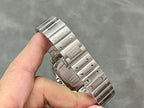 Stainless steel Cartier watch case and bracelet, viewed from the side