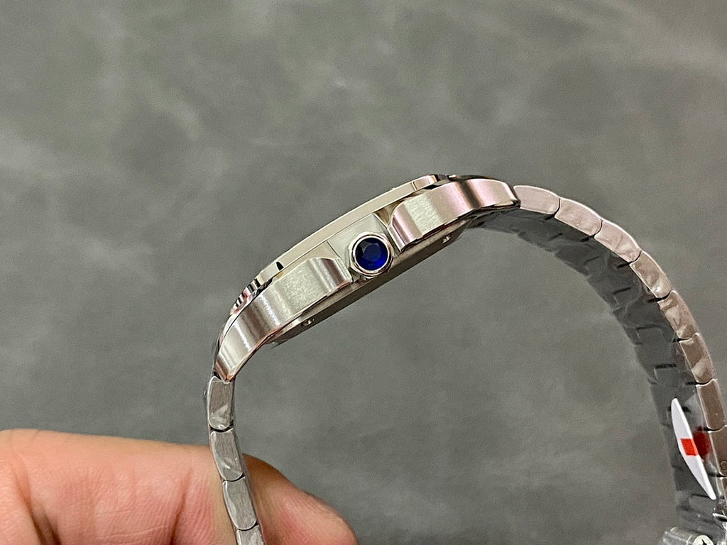 Stainless steel Cartier watch with blue sapphire crown on the top edge