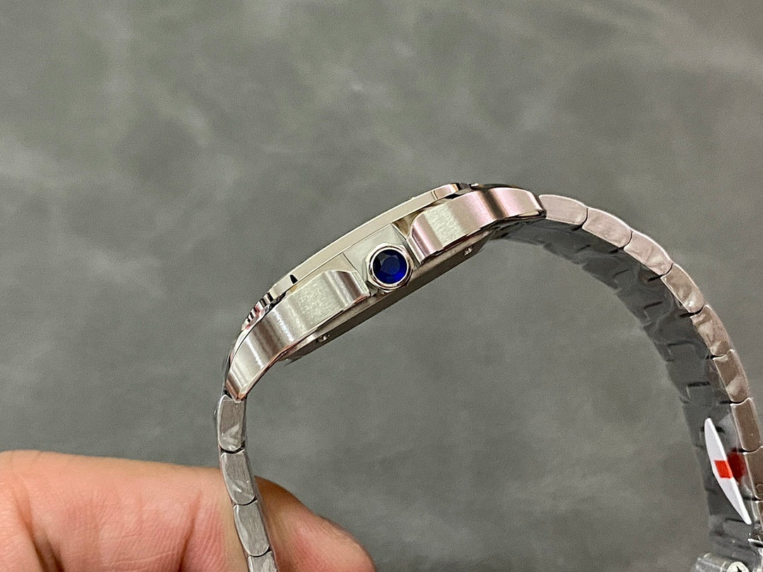 Stainless steel Cartier watch with blue sapphire crown on the top edge