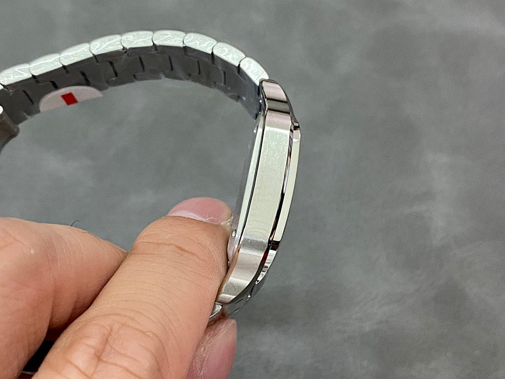 Stainless steel watch bracelet link view with red accent on one segment