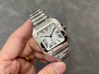 Stainless steel Cartier watch with white dial and Roman numerals, held in hand