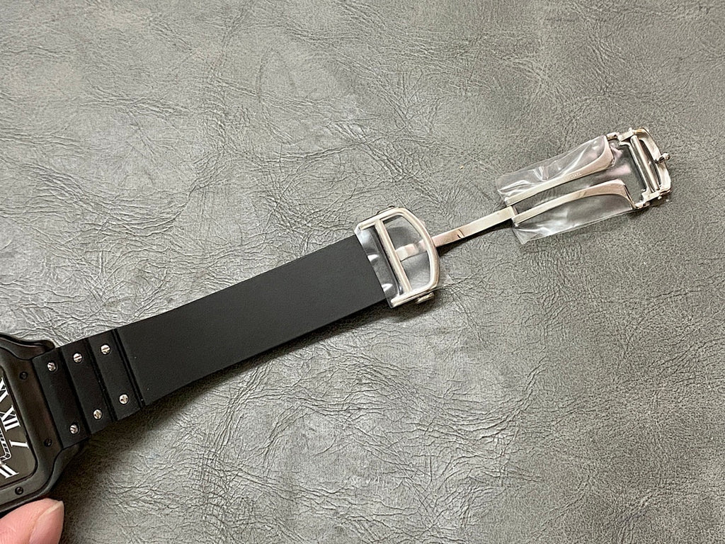 Cartier watch clasp with black strap and silver buckle hardware.