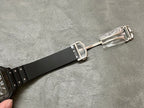 Cartier watch clasp with black strap and silver buckle hardware.