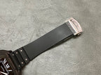 Cartier watch strap end with black band and silver buckle.