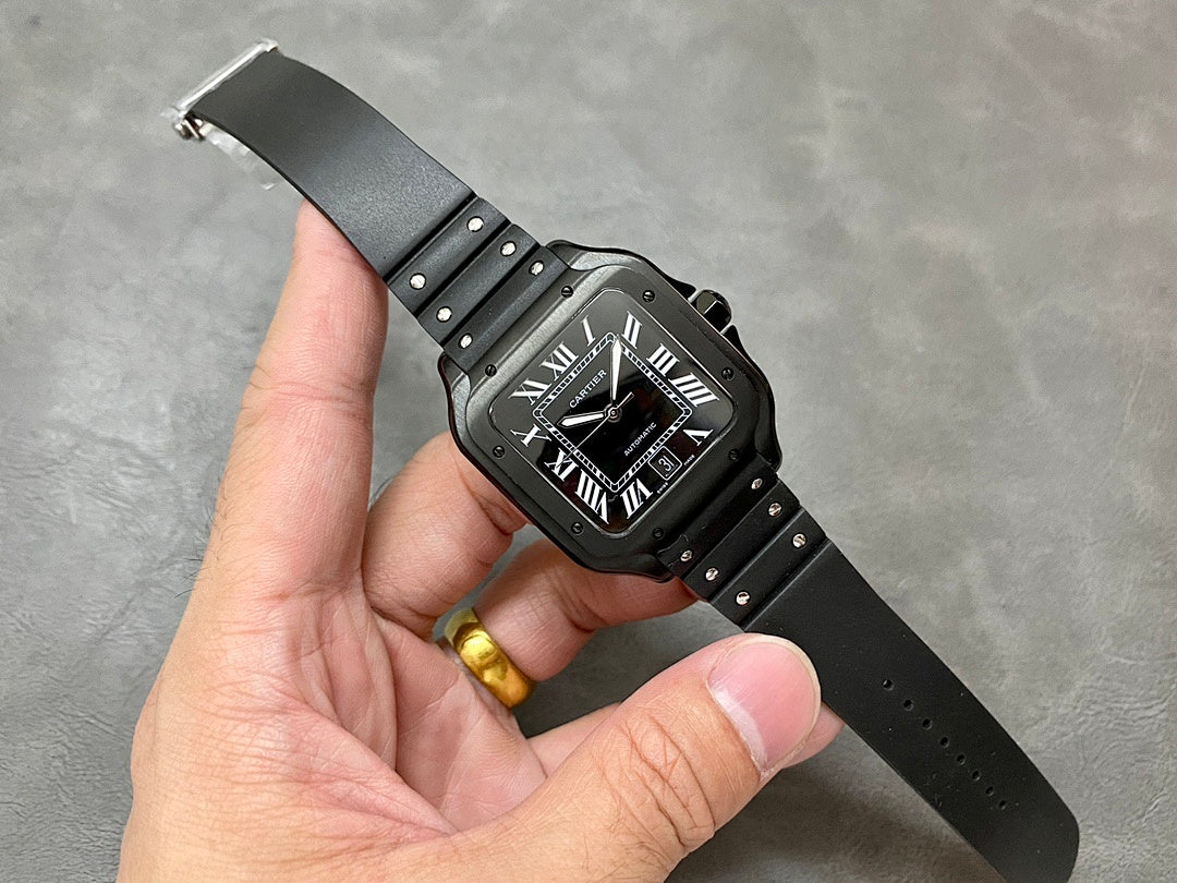 Cartier watch on black strap with Roman numerals dial and visible metal clasp.
