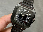 Cartier watch with black dial, Roman numerals, date window, and black rubber strap.