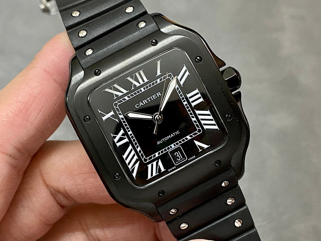 Cartier watch front with black dial, Roman numerals, date window, and metal bezel.