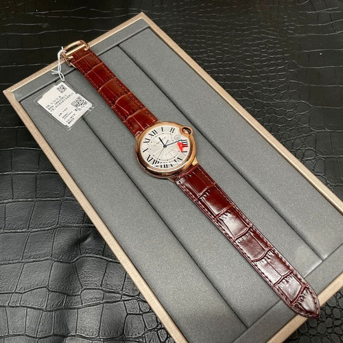 Cartier wristwatch on display box with brown leather strap and rose-gold round case