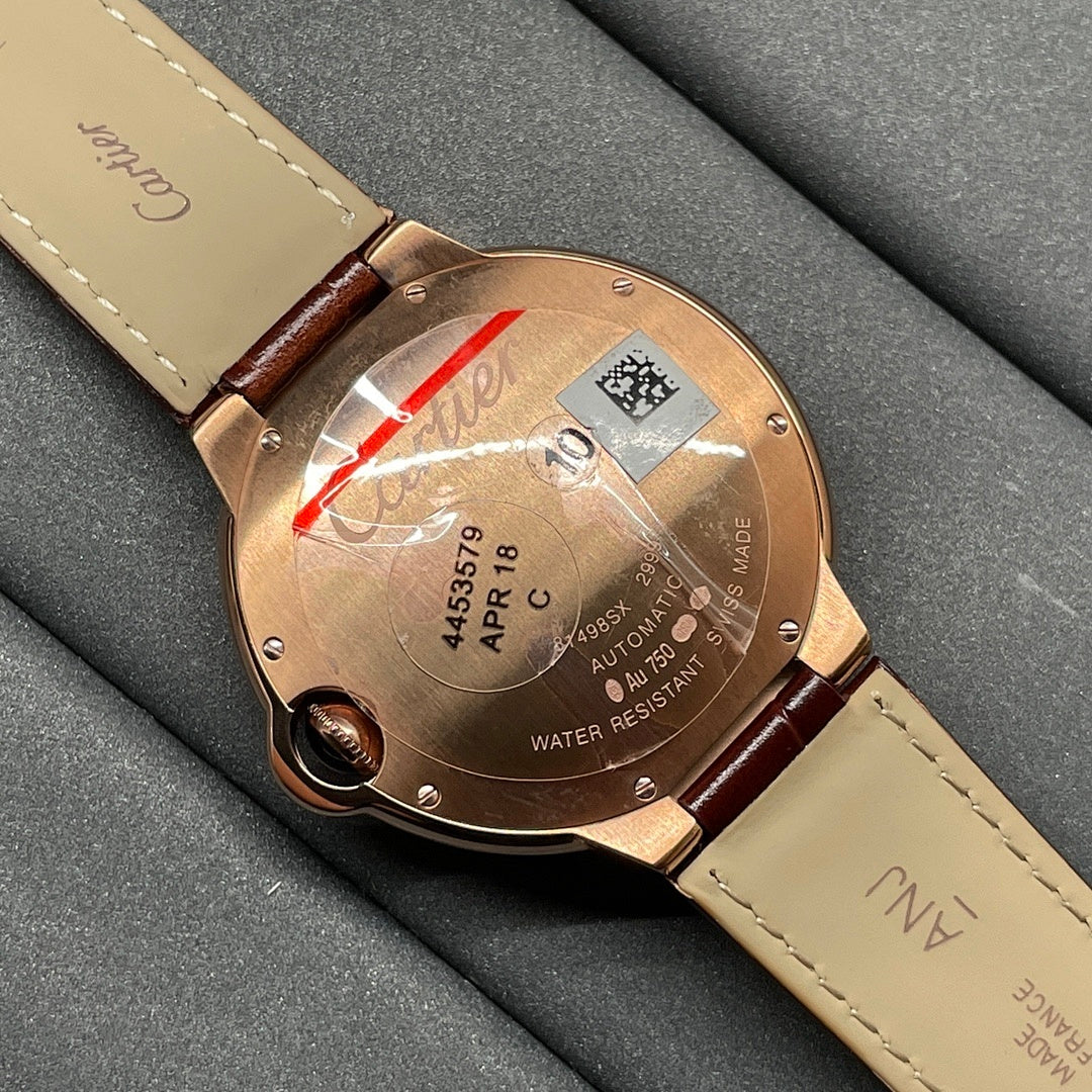 Cartier wristwatch caseback with engraved details and brown leather strap, rose-gold tone