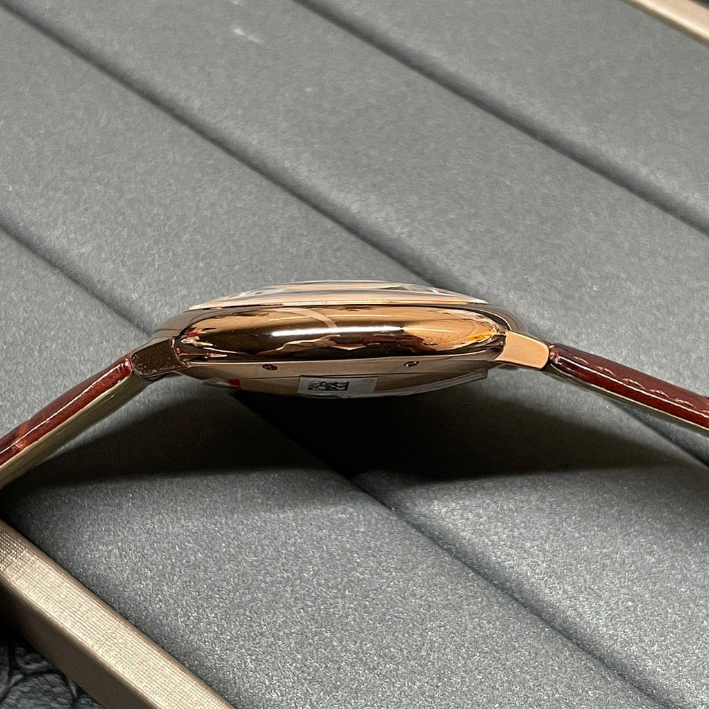Cartier wristwatch side view with polished rose-gold case and brown leather strap