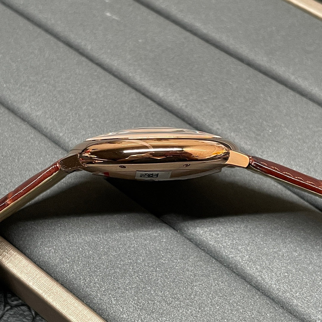 Cartier wristwatch side view with polished rose-gold case and brown leather strap