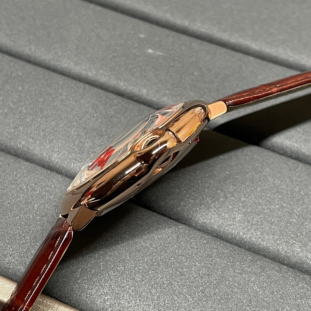 Cartier wristwatch side view with crown and rose-gold tone case, brown leather strap