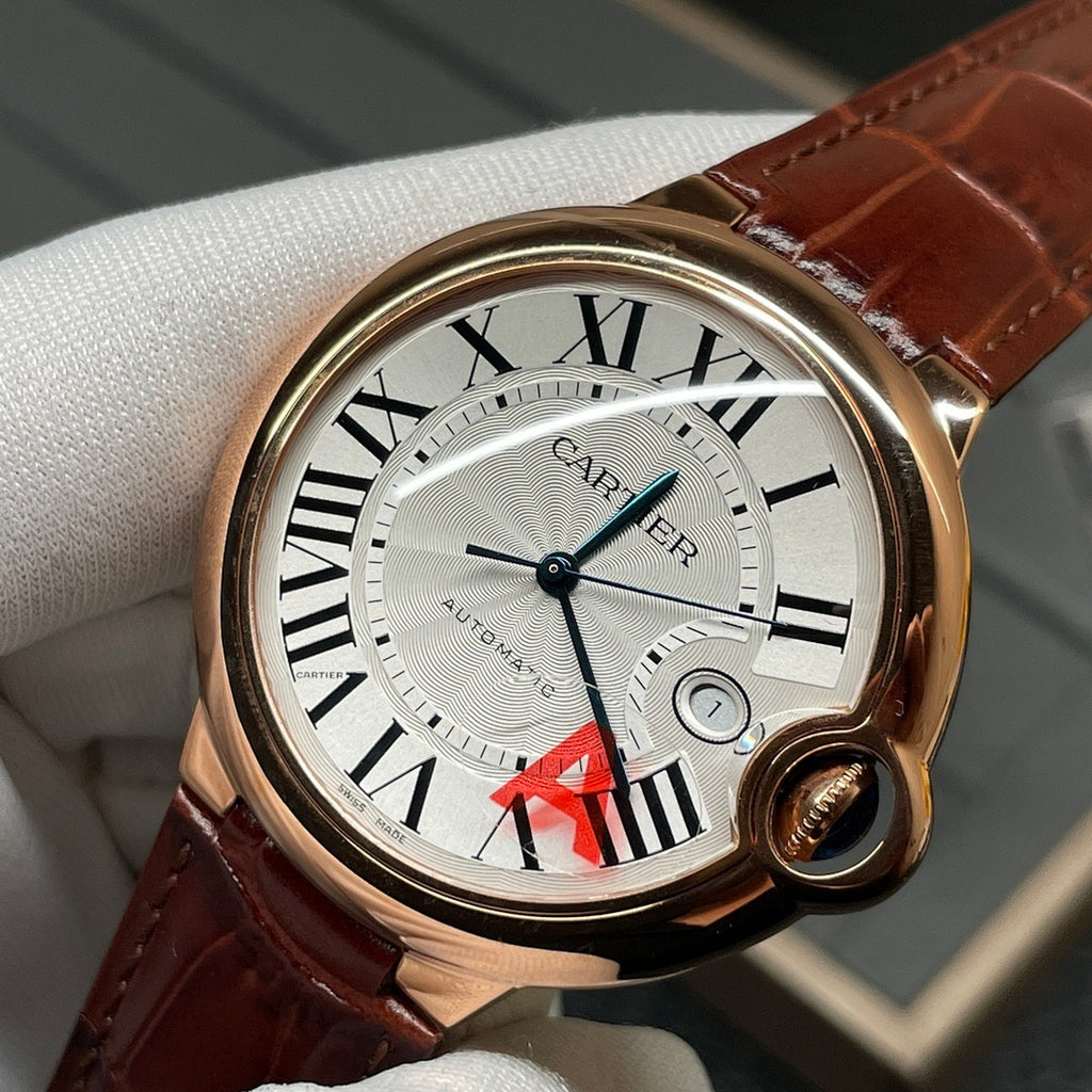 Cartier wristwatch close-up with brown leather strap, rose-gold case, Roman numeral dial