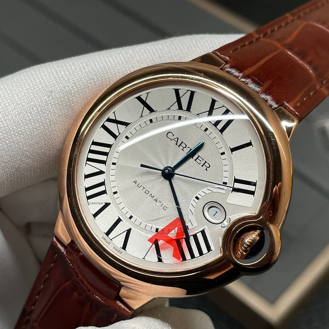 Cartier wristwatch close-up with brown leather strap, rose-gold case, Roman numeral dial