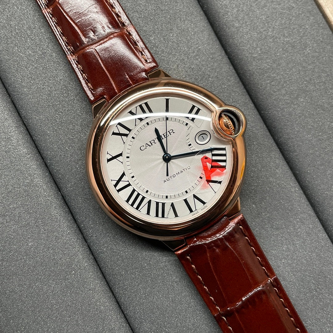 Cartier wristwatch angled view with brown leather strap and round rose-gold dial