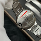 Cartier watch case back in stainless steel with red marker stripe and engraved details