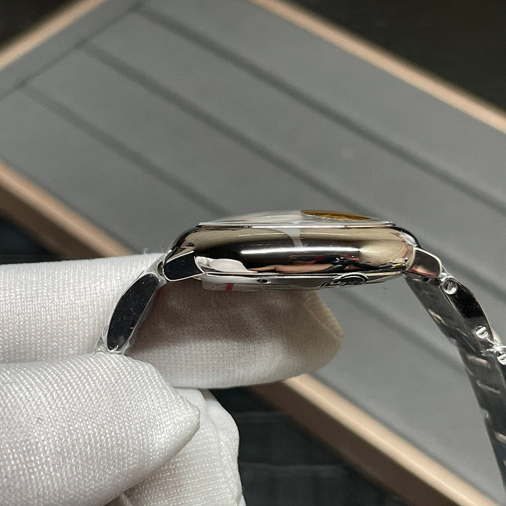 Stainless-steel Cartier watch case with polished bezel and crown, side profile
