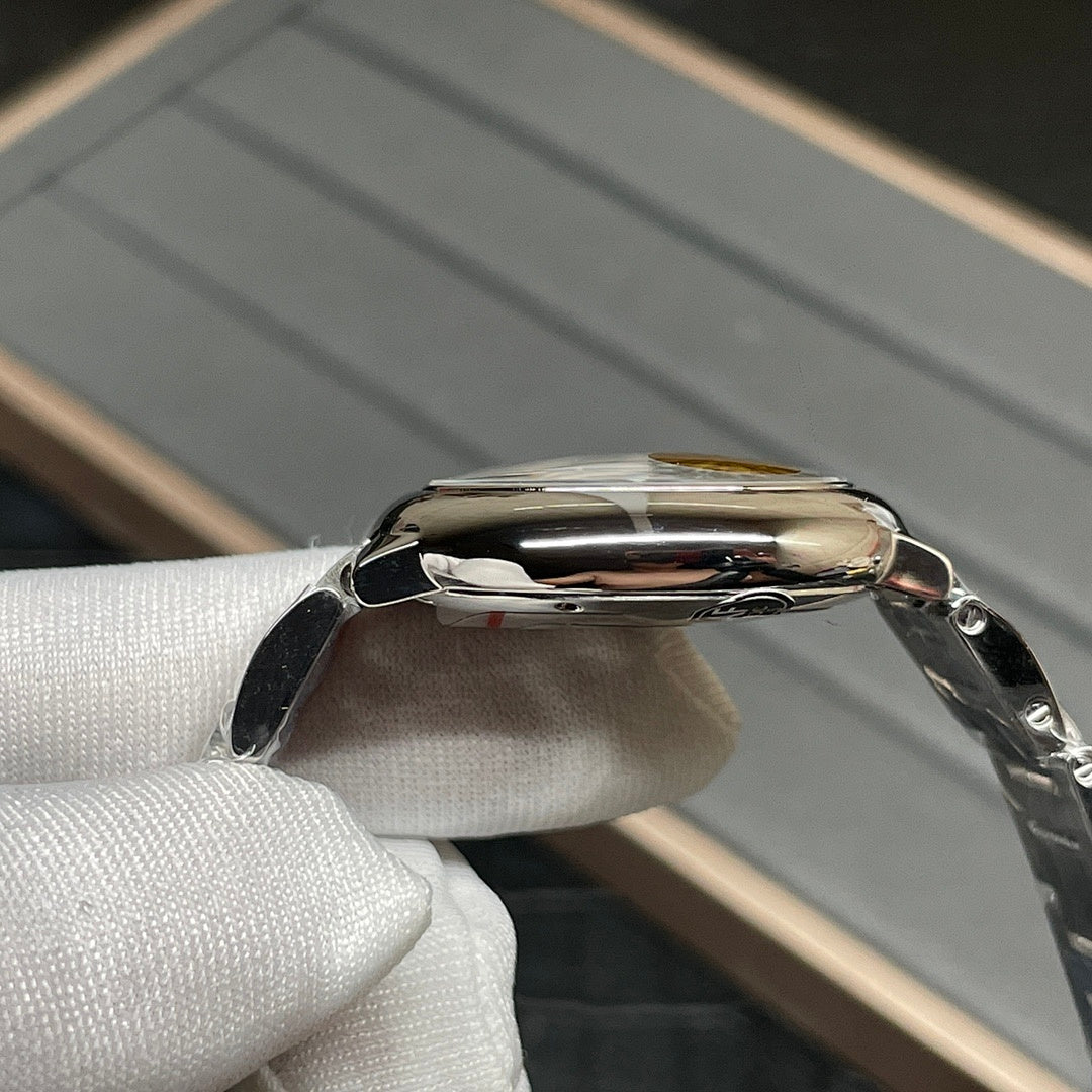 Stainless-steel Cartier watch case with polished bezel and crown, side profile