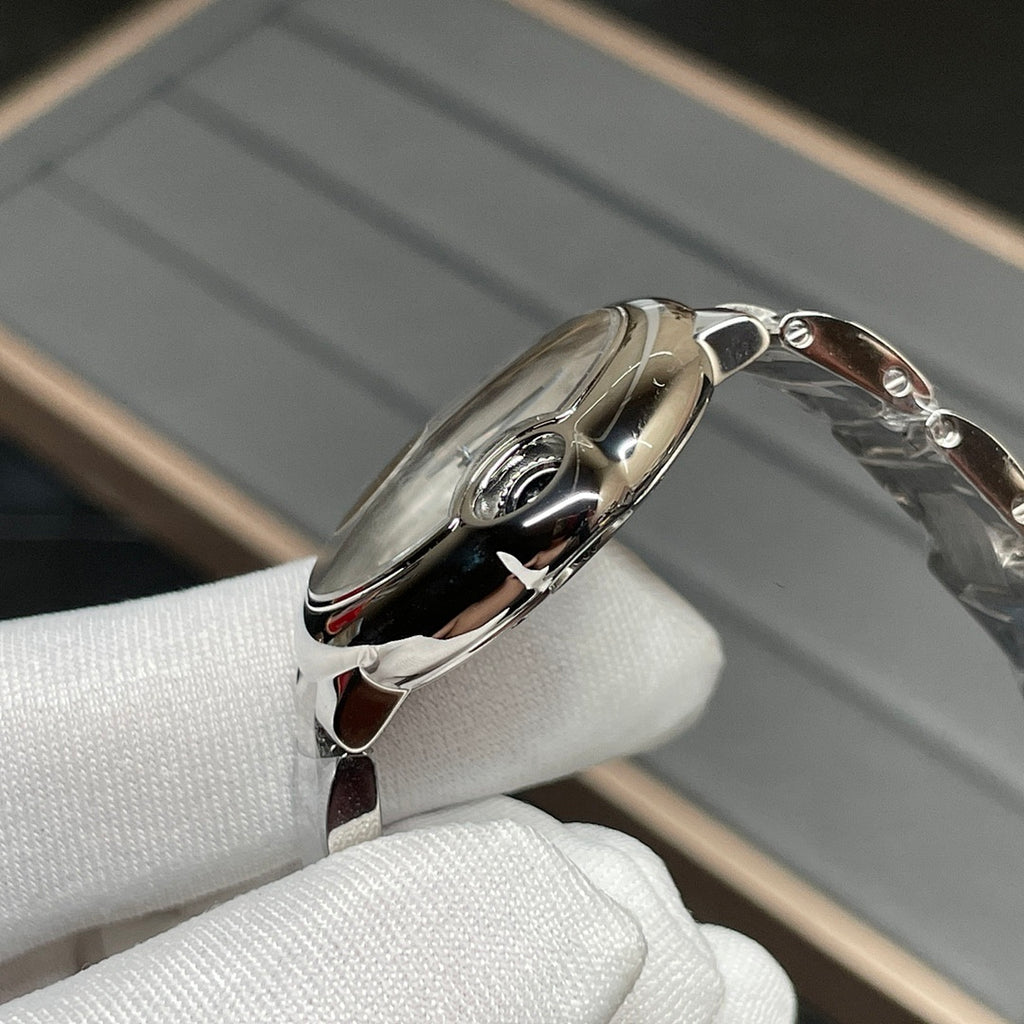 Stainless-steel Cartier watch case with crown and curved bezel, side view